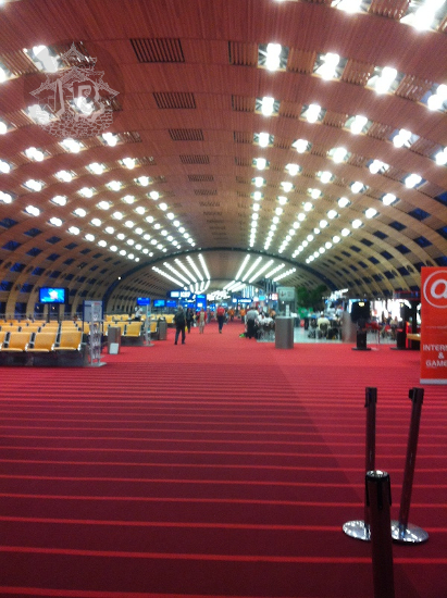 A very long airport lounge with a burgundy carpet