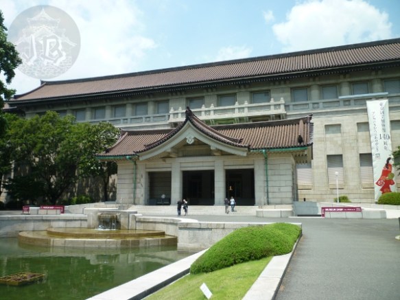 The entrance of the National Museum of Art, a light grey building with a brick roof
