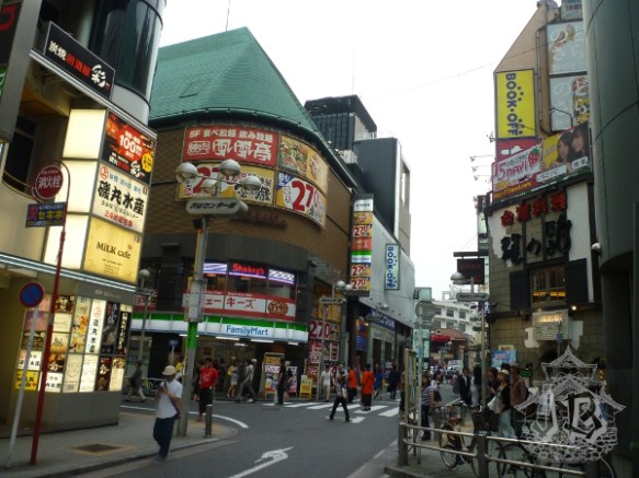 A shopping street in Shibuya. One of the billboards on the right reads Book Off