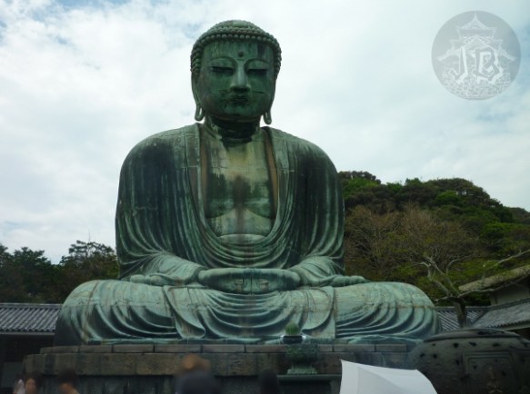 The great Buddha, sitting cross-legged with a peaceful expression