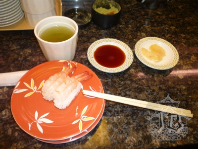 Close up of prawn sushi and green tea