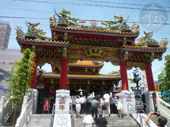 An ellaborate temple with guarding dragons on top, over a flight of stairs. The colours are very bright, but the stairs are white.