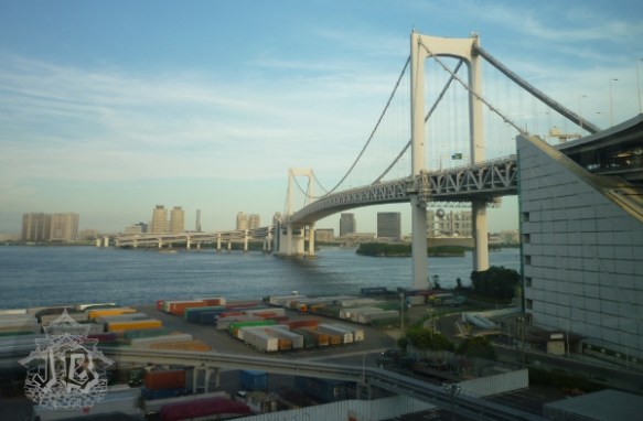 Rainbow bridge, which is white, extending over Tokyo Bay
