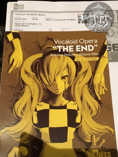 Booklet and ticket. Both read Vocalod Opera the end, with the dates. The booklet shows an image of Hatsune Miku, crying blood, the whole booklet is tinted yellow