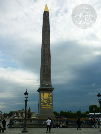 A black Egyptian obelisk with golden decoration