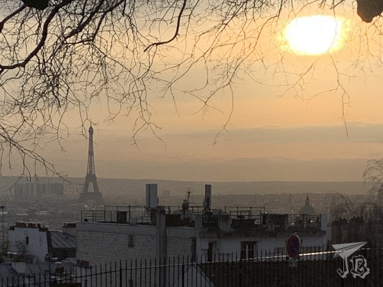 A profile of the Eiffel Tower in a blurry sunset in orange tones