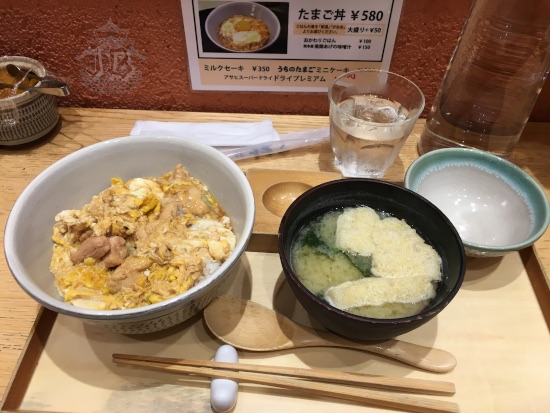 Lunch. A bowl of miso soup and a bowl of rice with cooked egg on top