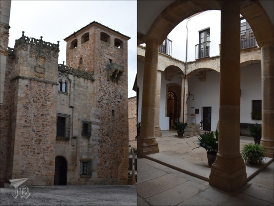 Gothic palace, with an ornate roof and a small cloister or patio.