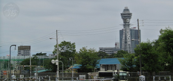 A wide shot of Osaka, showing the Tsutenkaku TV tower on the right