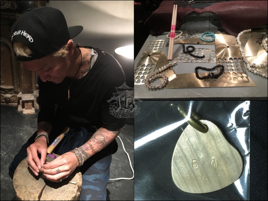 The artist engraving the pendant, and the material - old cymbals cut out in a heart-shape.