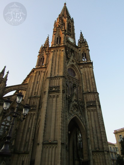 A gothic or neogothic church clock tower, spiky with pointy arches