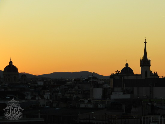 Sunset over the skyline of vienna. The buildings are dark and the sky is orange