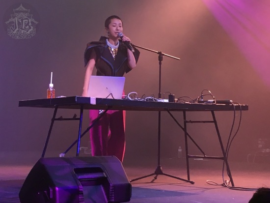 Woman rapping behind a mixing table
