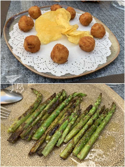 Plate of perfectly-round croquettes and some crisps in the middle + plate of roasted green wild asparagus
