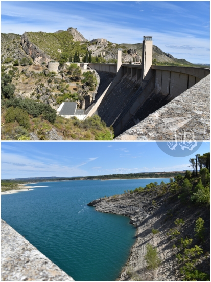 Massive concrete dam, and the water behind it, a rich azure. The water looks cool.
