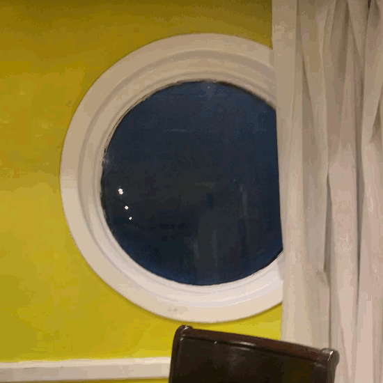 Animation of the porthole just above water, showing how the ship moves up and forward at the same time