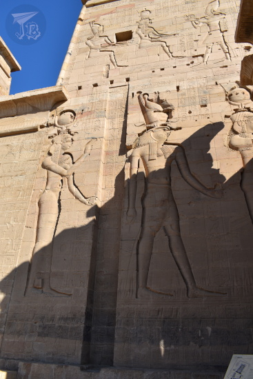 Close up of the pylon showing carvings of Hathor and Horus. Two water lines can be appreciated above and below them