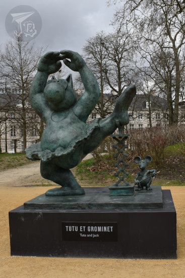 An obese, anthropomorfic cat on a tutu raising a leg while a mouse uses a jack to keep the cat's leg up.