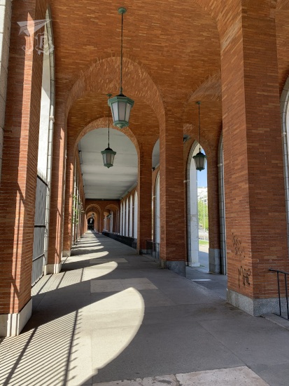 The archway in Nuevos Ministerios, built in reddish brick and white plaster