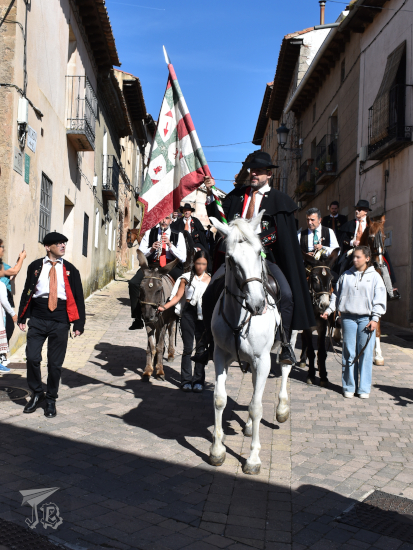 Caballada de Atienza: Horse parade in a Medieval Village. Senior brother with the flag, followed by musicians on mules.