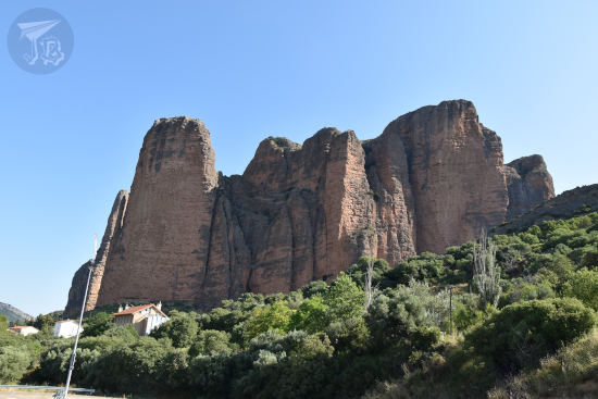Looking up at the Mallos de Riglos, vertical structures made from reddis conglomerates