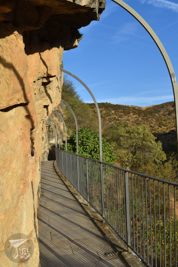 Walkway alongside the vertical rock wall.