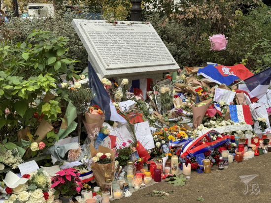 Memorial in front of the Bataclan concert venue, with a plaque and hundreds of flowers.