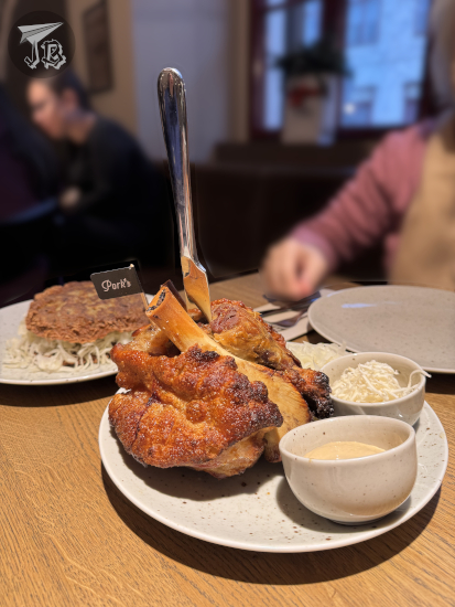 Pork knuckles portion with cabbage and mustard.