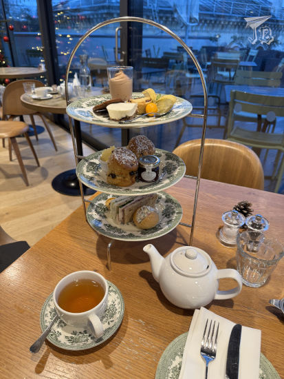 Afternoon tea, on a three-storied tray, along with a cuppa.