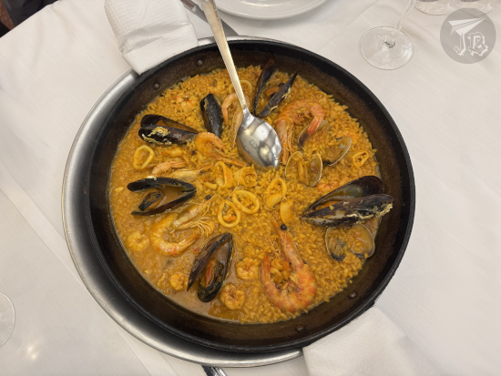 Paella - large pan with cooked rice with mussels and prawns
