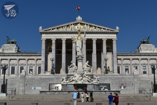 Neoclassical building with the statue of a Greek goddess standing in front
